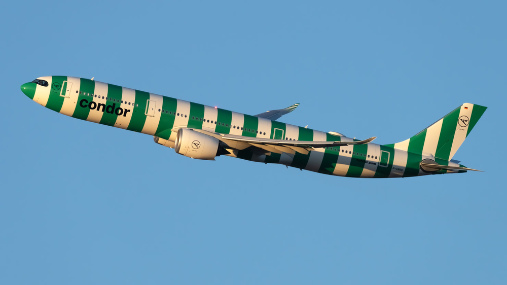 Condor Airlines Plane Taking Off From Seattle Green and White Stipes wrapped around the plane.