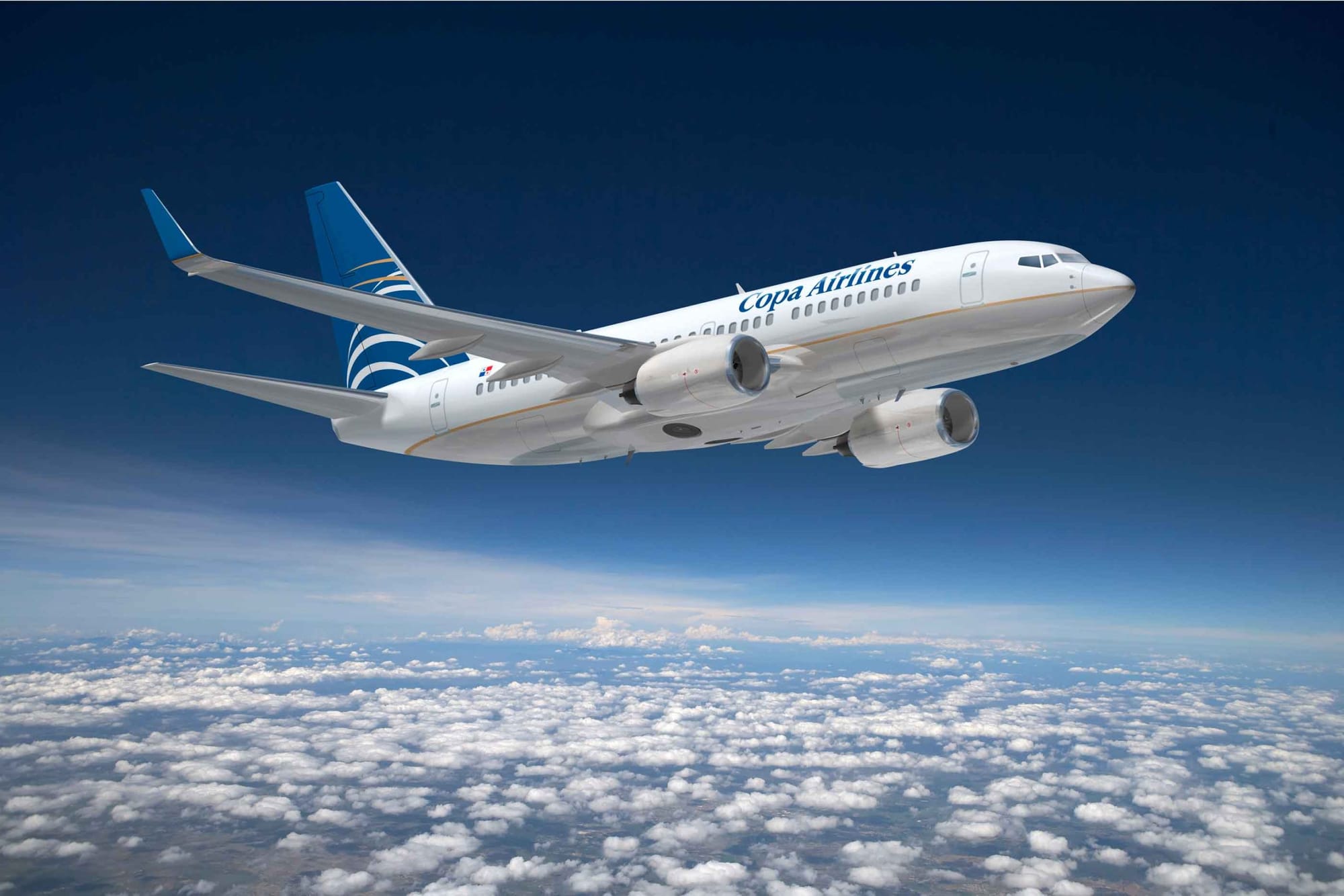 Copa Airlines aircraft flying above the clouds under a deep blue sky.