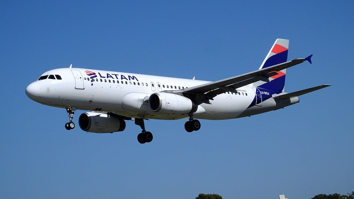 LATAM Airlines plane putting it's landing gear down as it comes it for a landing.