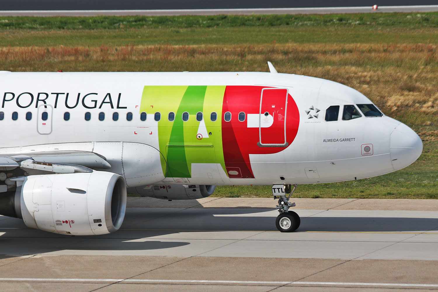 TAP Air Portugal Airbus on taxiway in Chicago with airline's red and green logo visible.