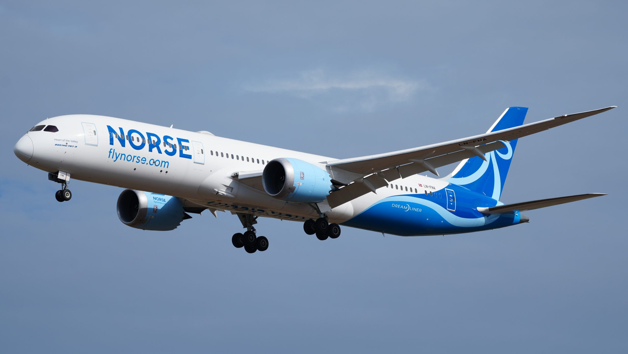 A Norse Airline Plane coming in for a landing at an airport.