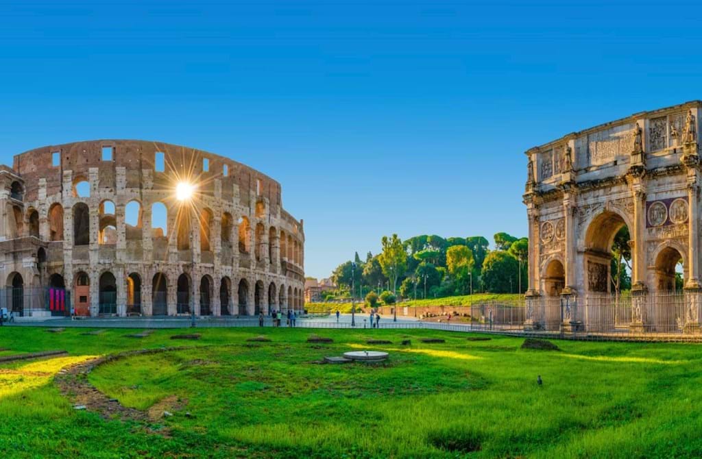 Morning sunlight shines through the arches of the ancient Colosseum in Rome.