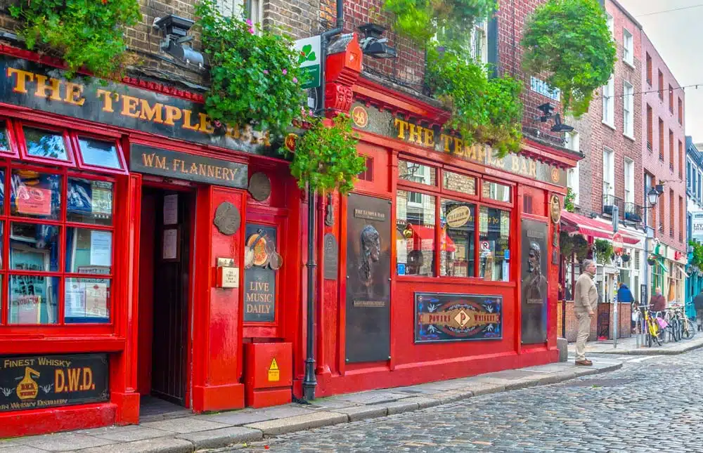 Bright red Temple Bar pub in Dublin’s historic cobbled district.