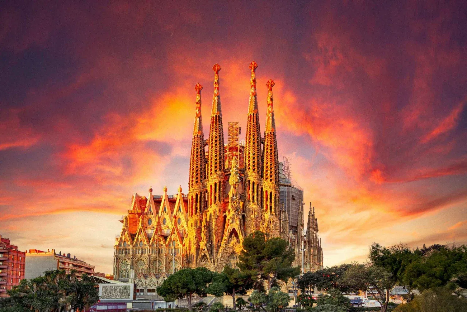 Gaudí’s Sagrada Família glows at sunset in Barcelona with vivid, fiery skies.