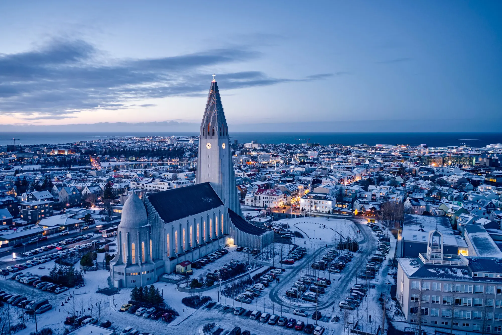 Winter twilight over snowy Reykjavik with Hallgrímskirkja Church rising above the city.