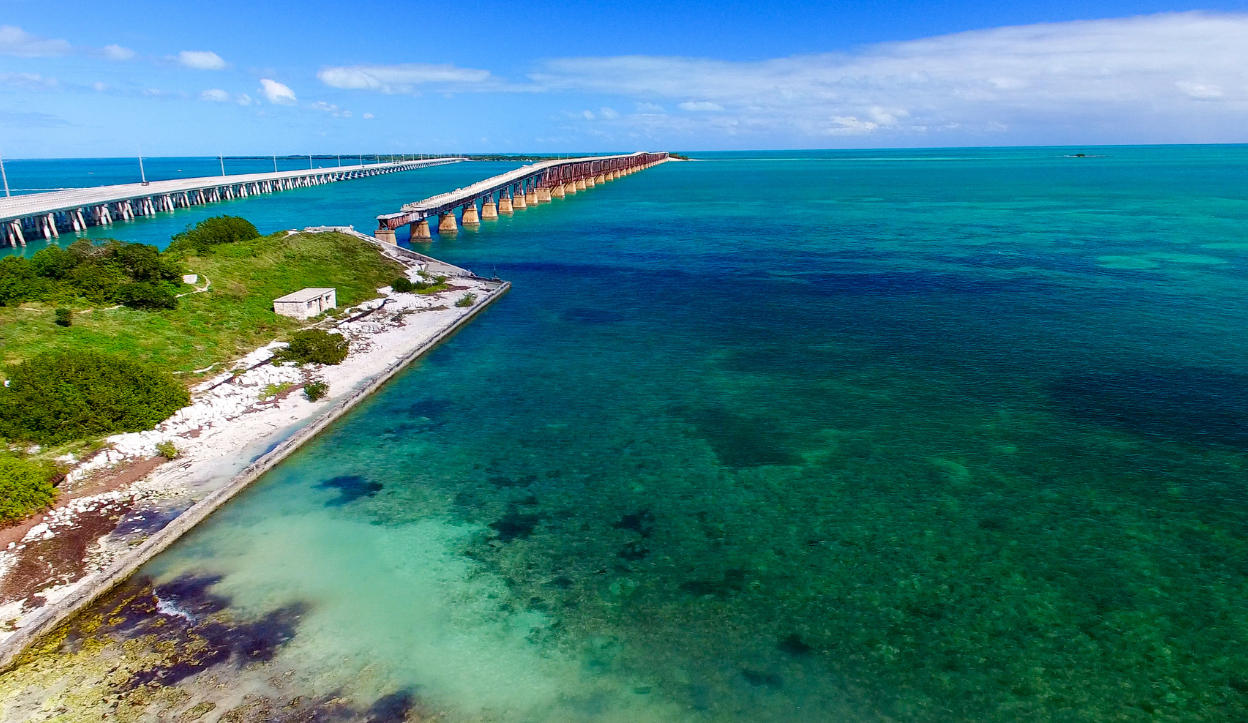 Aerial view of clear blue waters and the old railroad bridge at Bahia Honda State Park in the Florida Keys.