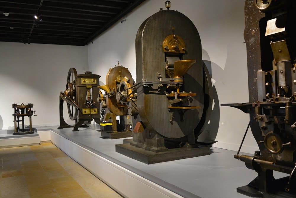 Historic coin minting machines on display at Casa de Moneda in Bogotá, Colombia, showcasing antique industrial equipment used for currency production.