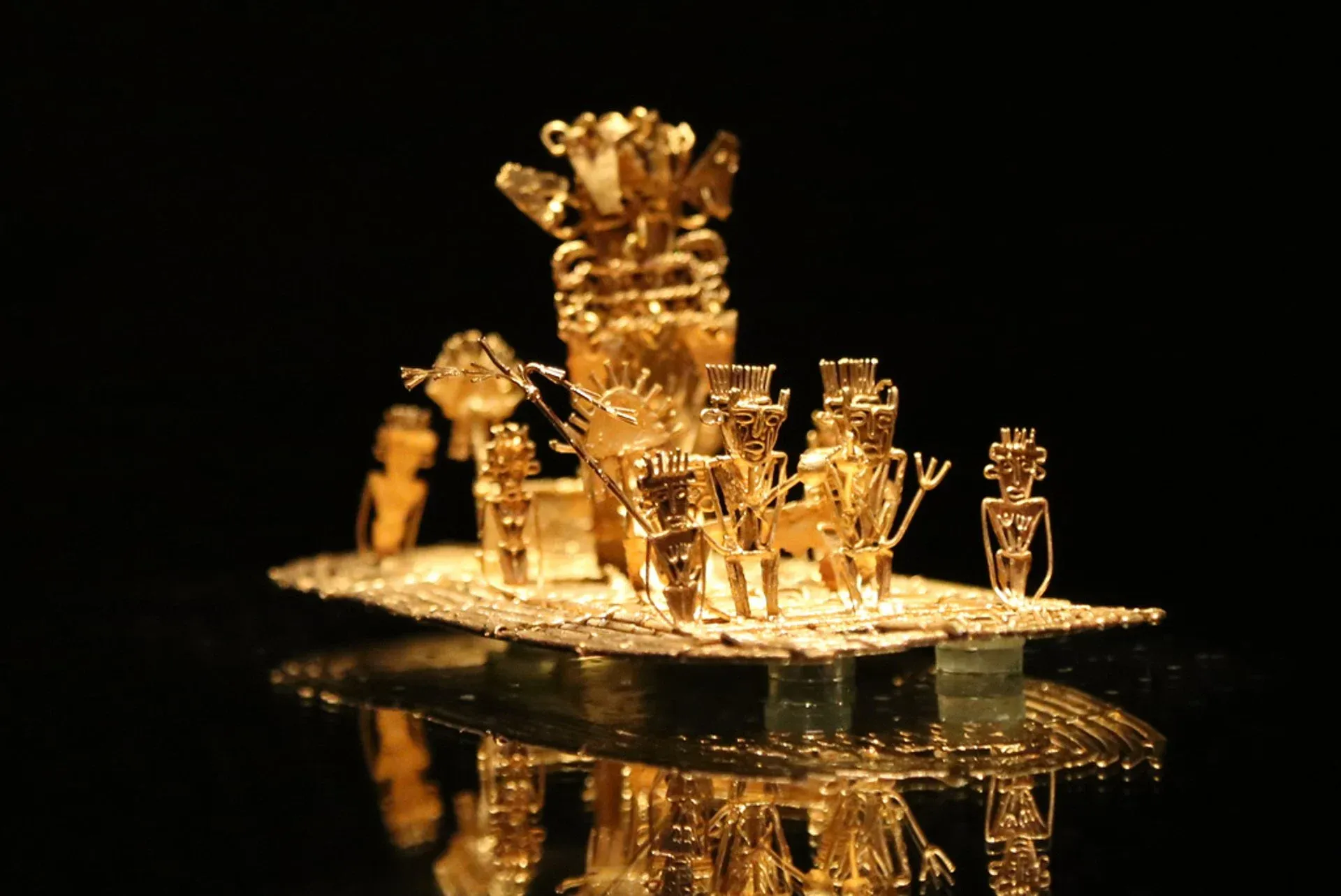 Close-up of the famous Muisca raft, a pre-Columbian gold artifact displayed at the Museo del Oro in Bogotá, Colombia, symbolizing the El Dorado ritual with intricate human and animal figures.