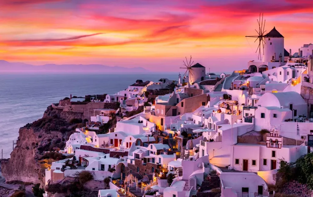 View of white buildings in Oia, Santorini, Greece at Sunset.