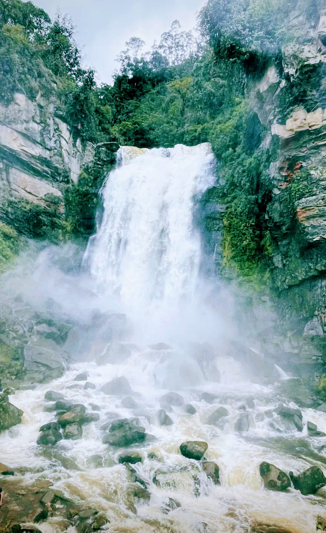 Mist in the air from the waterfall of Cascada de Sueva smashing into the rocky creek below.