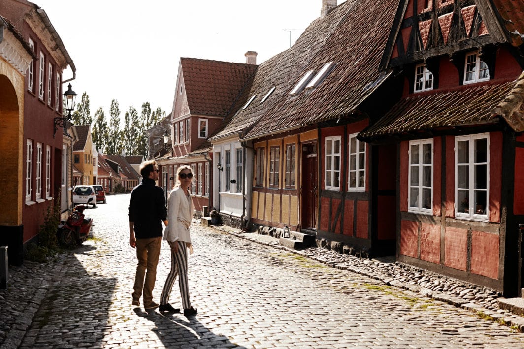Two people walking the streets of Ærøskøbing, Denmark.