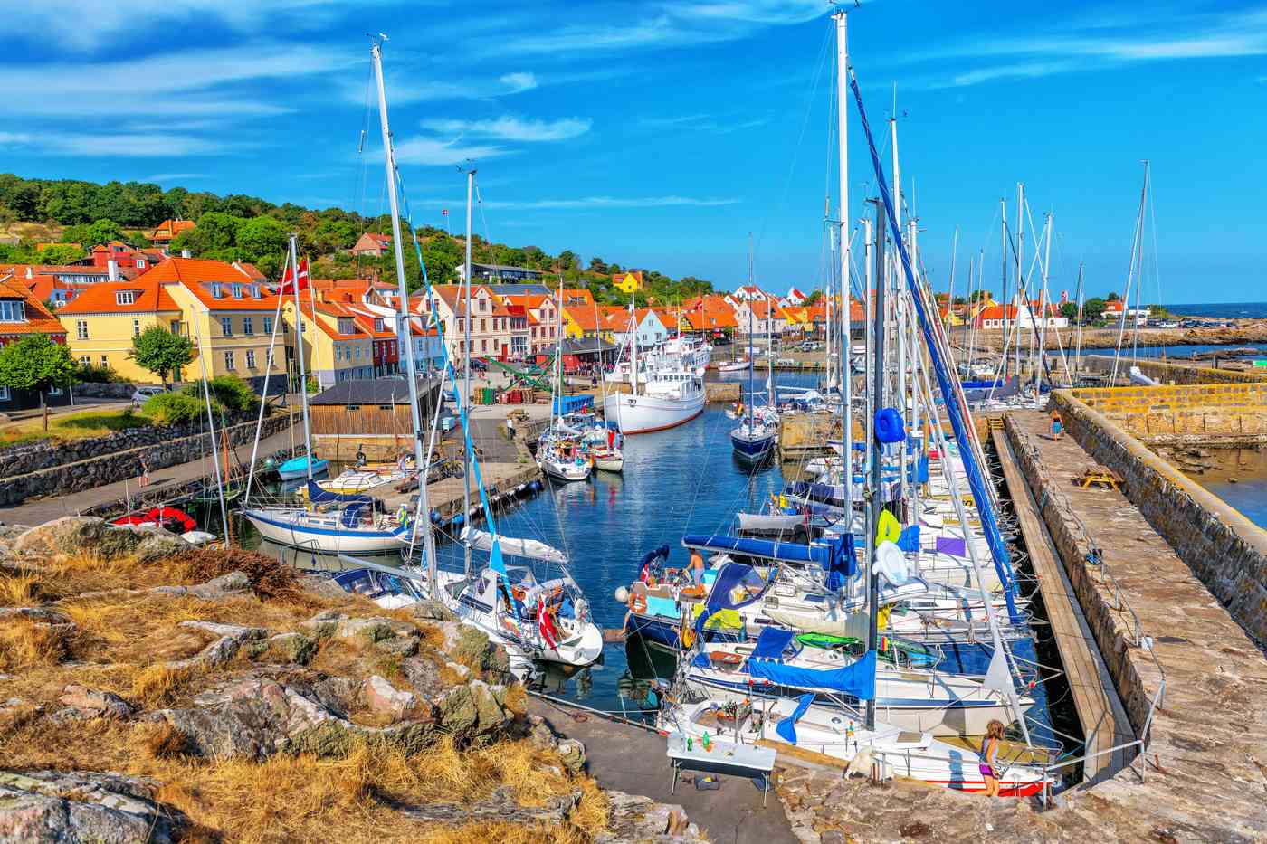 Boats at harbor on a sunny day in Gudhjem.