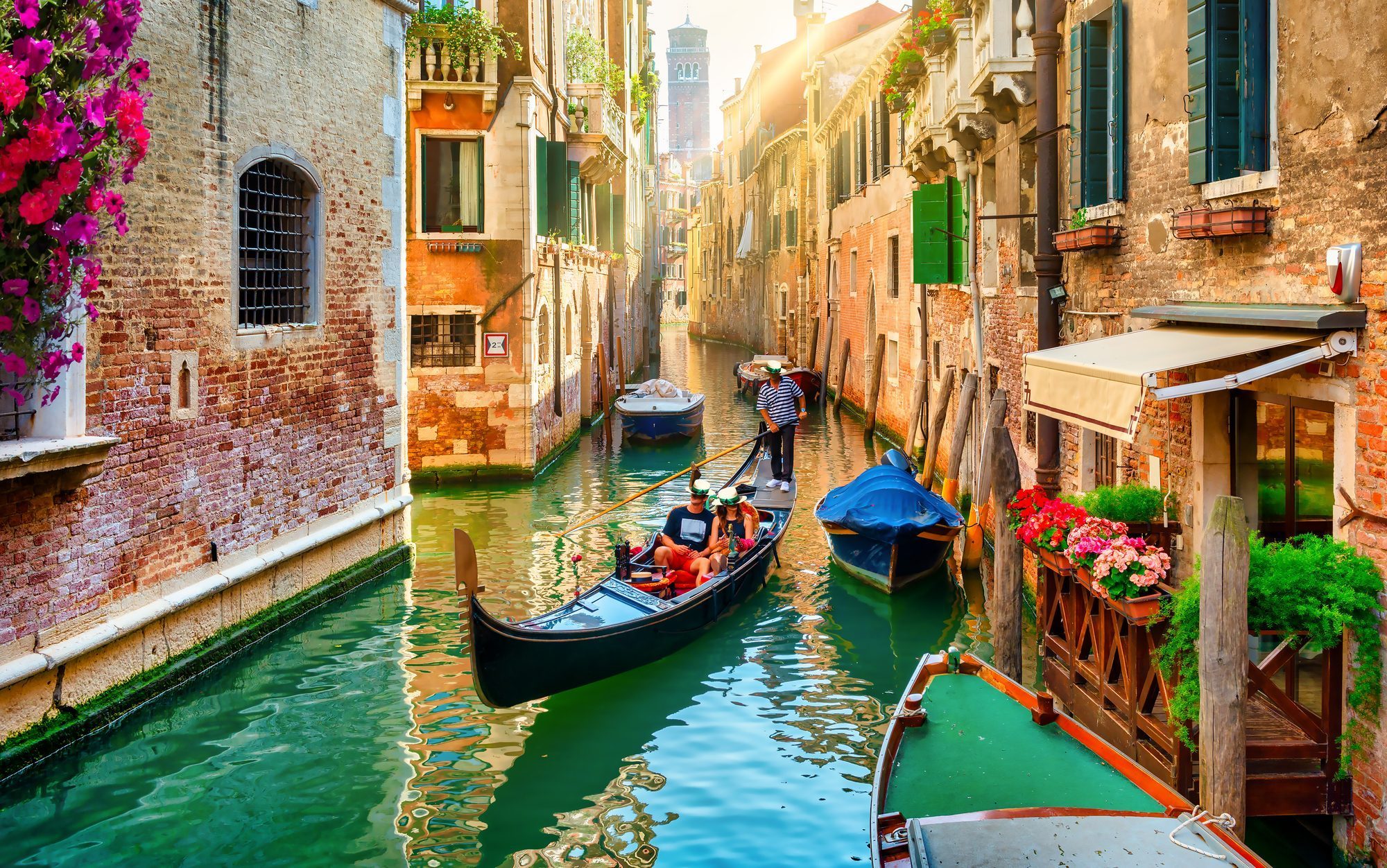 Riding a Gondola boat on a beautiful small canal in Venice, Italy.