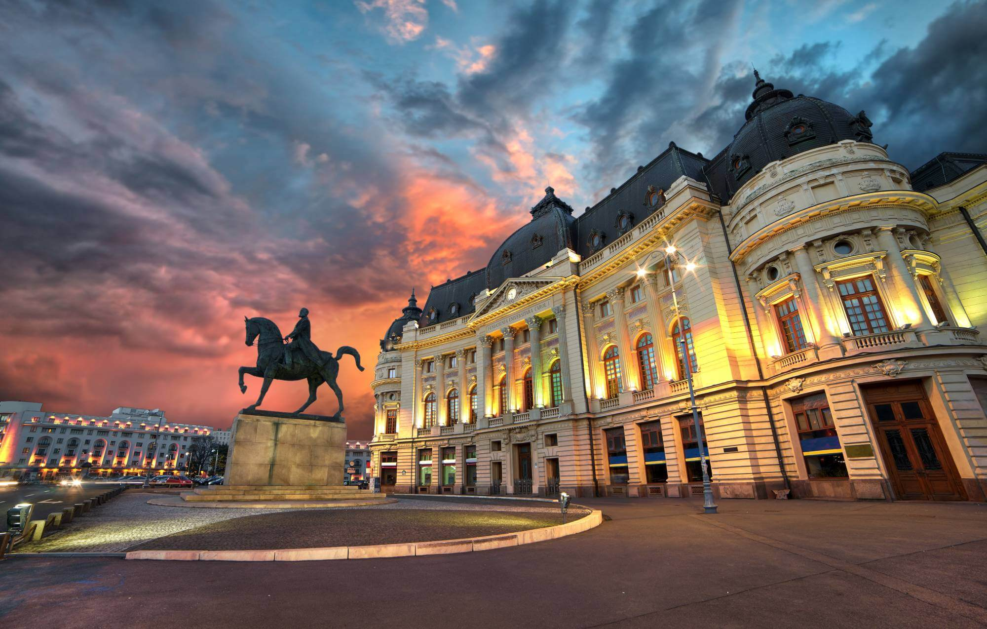 A beautiful building with a horse statue out front in Romania.
