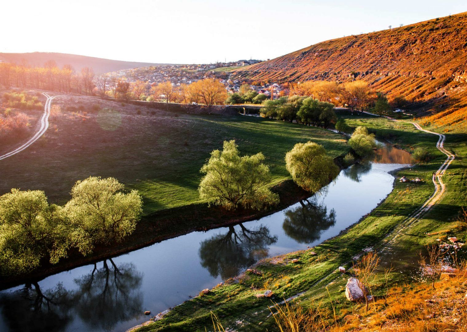 A river running through Moldova countryside on a sunny day.