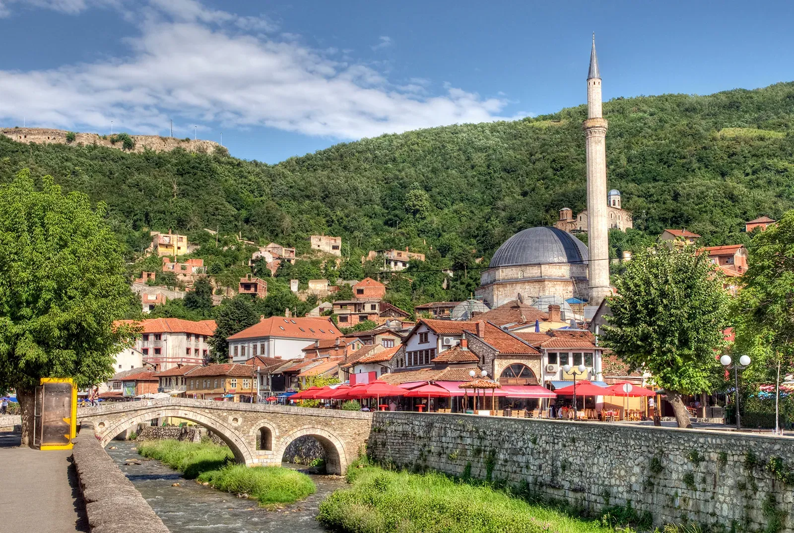 An old bridge next to a dome building in Kosovo.