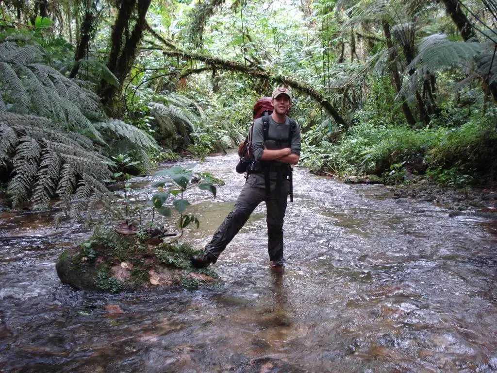 Man hiking up a creek in Sierra de las Minas Biosphere Reserve