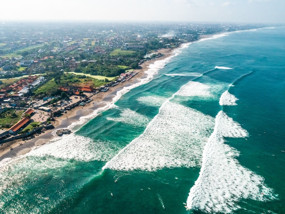 Canggu, Bali, Indonesia ariel view of waves washing ashore. 