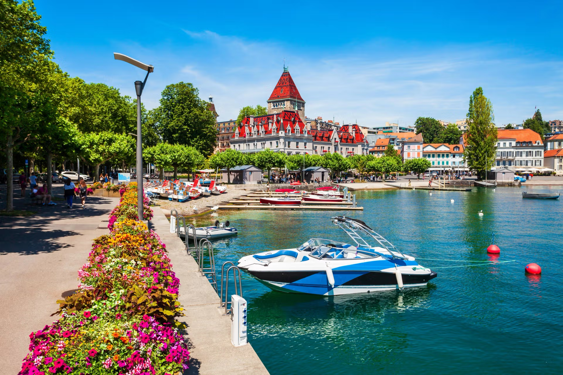 A boat in the lake with a city view of Lausanne, Switzerland.