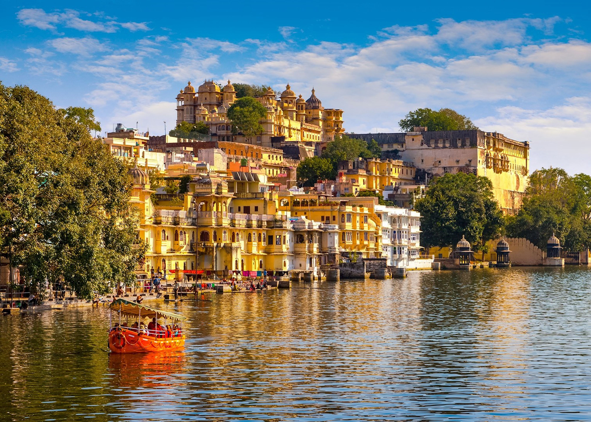A boat going down the river with tourist in Udaipur, India.