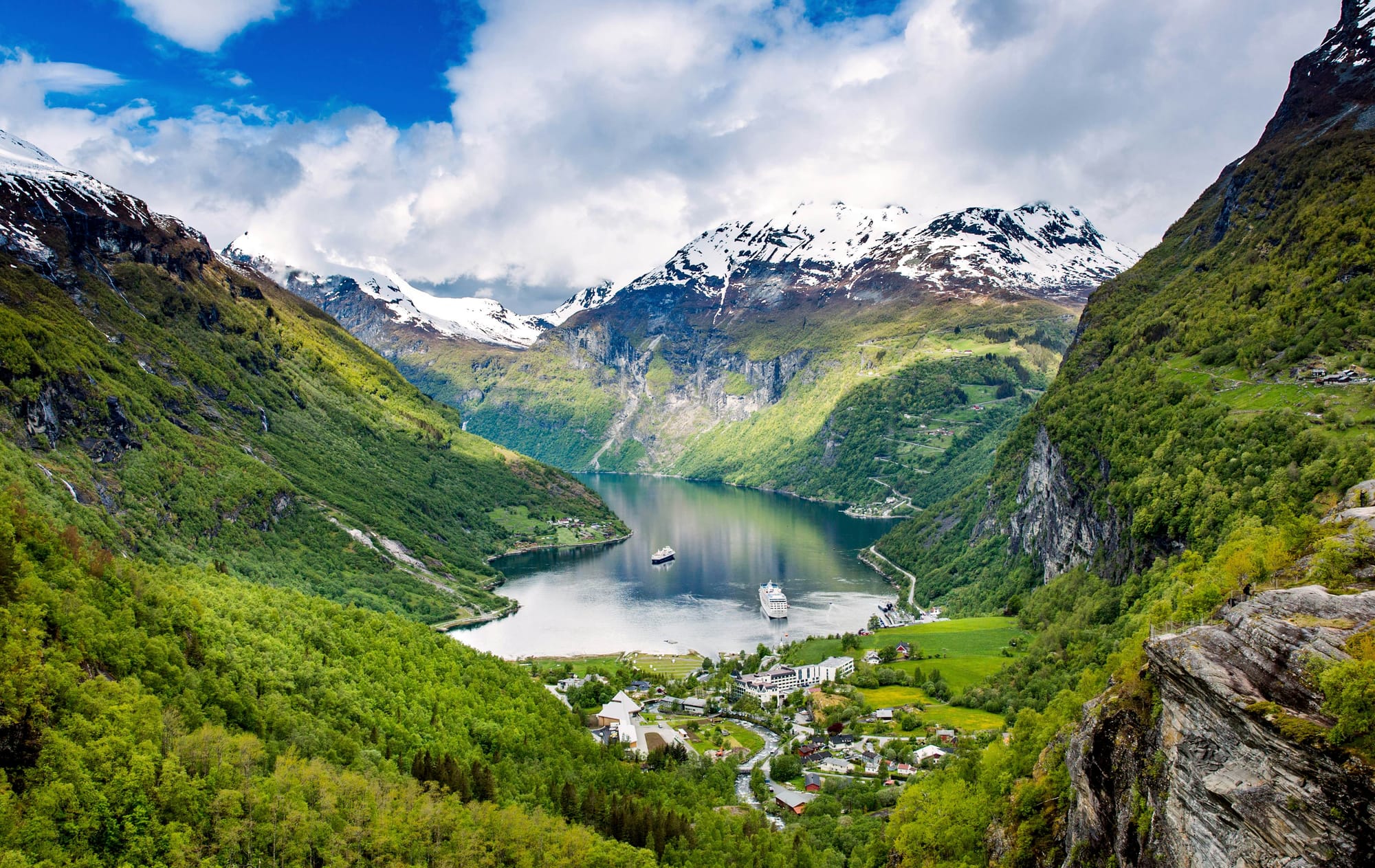 Beautiful fjord in Norway surrounded by mountain peaks covered in snow.