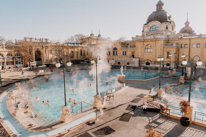 Steam coming off the pool at Széchenyi Thermal Baths in Budapest with people enjoying the water.