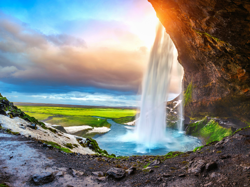 View from inside Seljalandsfoss waterfall in Iceland.