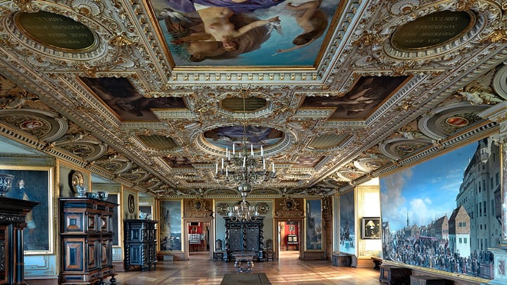 Interrior of Frederiksborg Castle in Copenhagen, Denmark showing beautiful ceilings and walls in artwork.