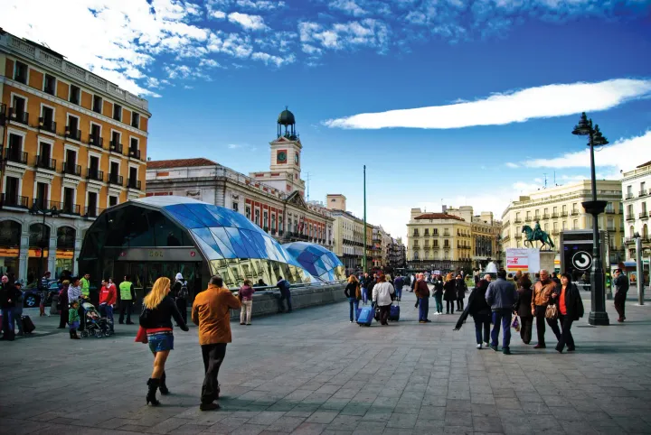 People walking in a busy area of Madrid's Sol Neighborhood.