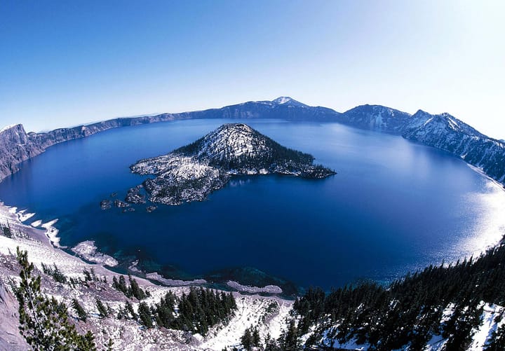 Crater Lake Oregon with snowy island, one of the most beautiful lakes in the United States.