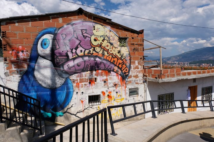 A Parrott Painted in Medellín, Colombia along a side walk for street Art