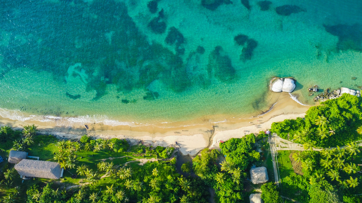 Ariel view of a beautiful beach with clear waters in Santa Marta, Colombia.