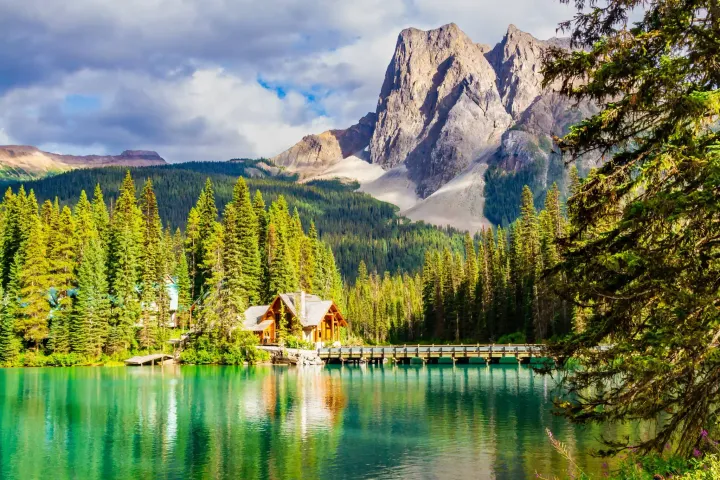 A beautiful lake with a cabin and mountain views in Canada. 