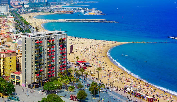Ariel view of the beaches in Barcelona with lots of people having fun on the beach.