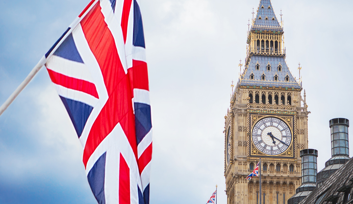 A view of the union jack flag in front of Big Ben Clock tower in London, England.