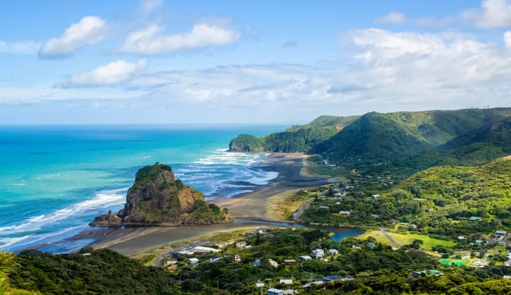 View of the beach and mountains at Piha beach in New Zealand.