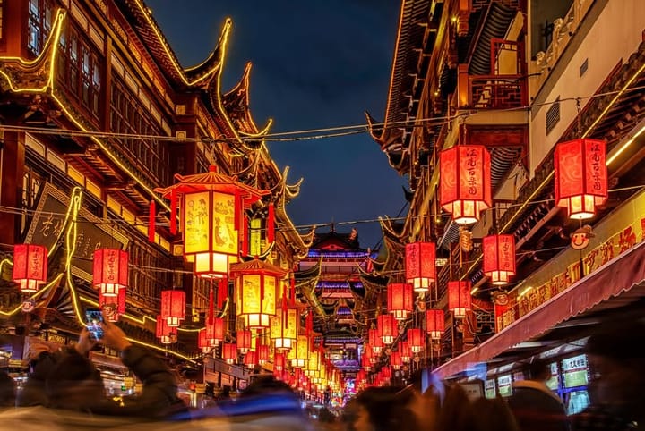 Red lantors lit up at night on the streets of Shanghai, China.