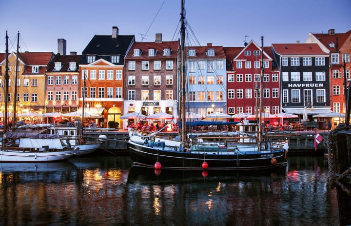 Boats anchored at Nyhavn waterfront in Copenhagen, Denmark.