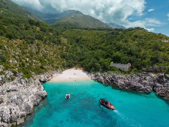 Boats near a beautiful beach with clear blue waters in Albania.