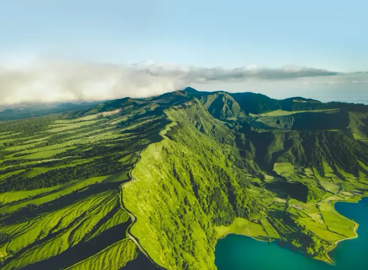 Azores Islands ariel view of lush green mountains overlooking the ocean.