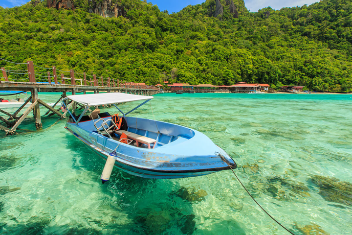 A boat floating in the clear waters in Malaysia.